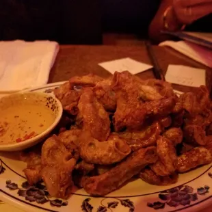 a plate of chicken wings with dipping sauce