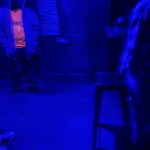 two men in a dark room