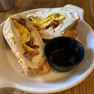 a plate with a sandwich and a cup of coffee