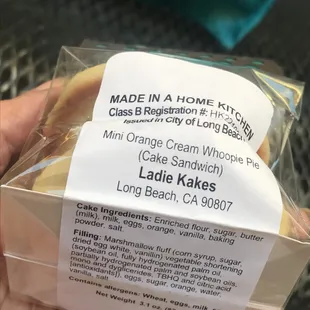 a hand holding a bag of cookies