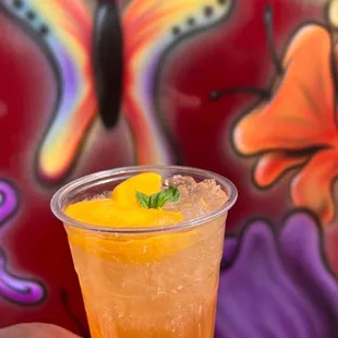 a hand holding a drink