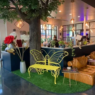 Plants, comfy seats, butterfly bench, bar area