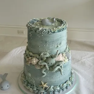 a three tiered cake decorated with sea creatures