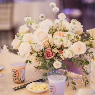 a table setting with flowers and candles