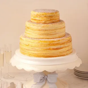 a stack of crepes on a cake stand