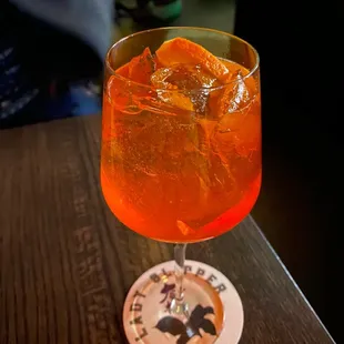a glass of orange drink on a table