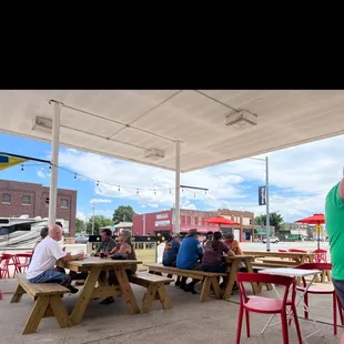 a group of people sitting at picnic tables