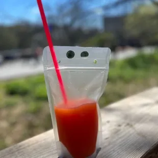 a drink in a plastic cup with a straw