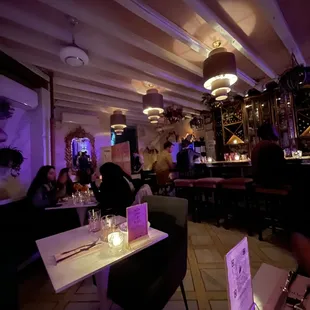 the interior of a restaurant with purple lighting