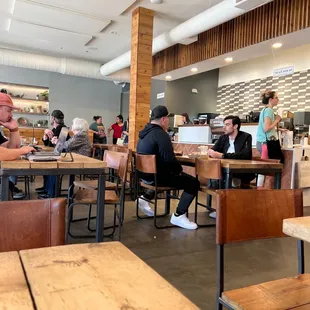 people sitting at tables in a restaurant