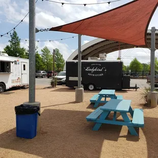 a picnic table and food truck