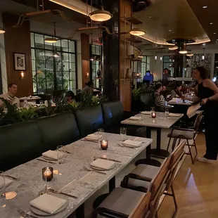a dining area with tables and chairs