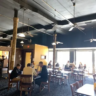 people sitting at tables and eating