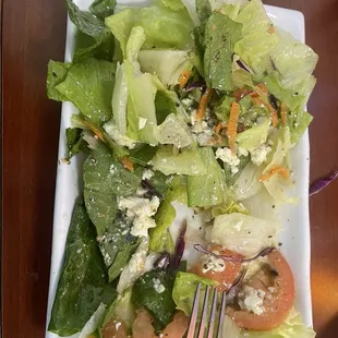 Fresh house, side salad featuring feta and sliced tomatoes.