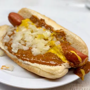 a hot dog with onions and mustard