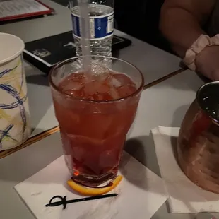 a drink in a glass on a napkin