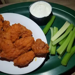 a plate of fried chicken and celery