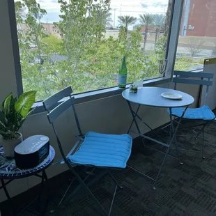 a table and chairs on a balcony