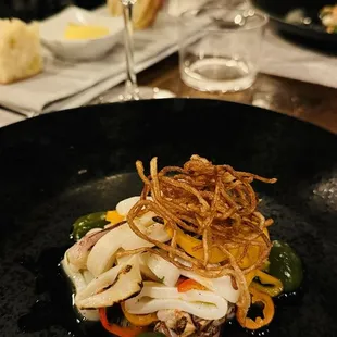 Calamari appetizer with fried string potatoes