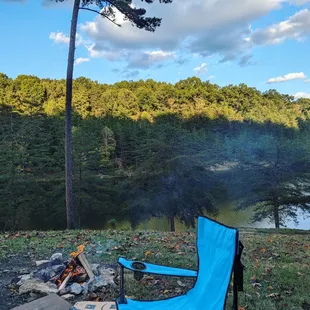 a camping chair by a campfire