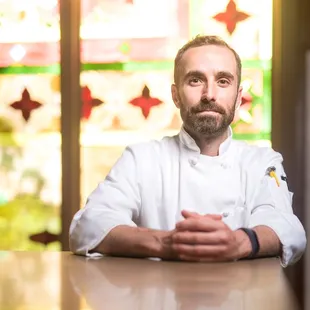a chef sitting at a table