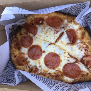 a pepperoni pizza in a box