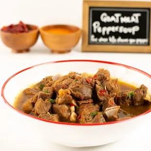 Savor Nigerian GoatMeat Peppersoup: tender sautéed chunks with intense spices, bursting with flavor. Served piping hot for ultimate enjoymen