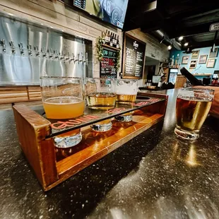 a flight of beers on a bar