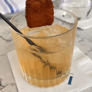 a cocktail with a piece of fried chicken