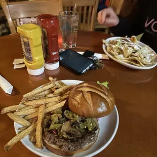 The build your own burger with green chile and sautéed mushrooms and nachos