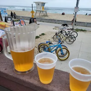 two cups of beer and a bicycle