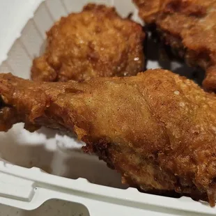 a close up of a chicken in a styrofoam container