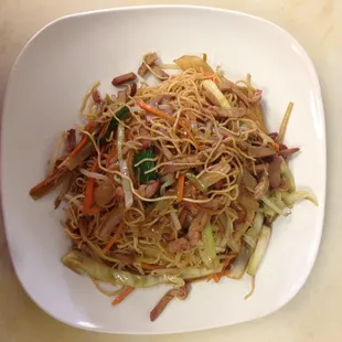 a plate of noodles with meat and vegetables
