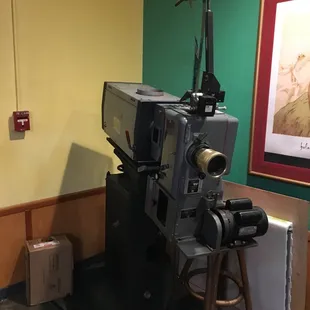 Old 35 mm projector on display in lobby.