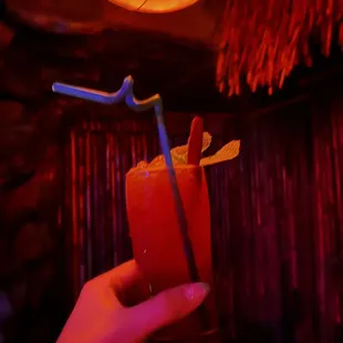 a hand holding a drink