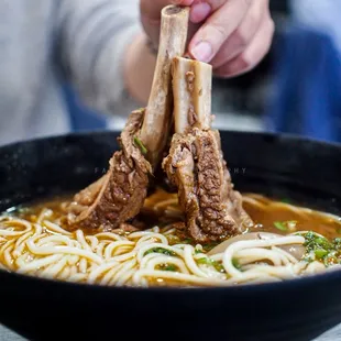 a bowl of ramen with chopsticks
