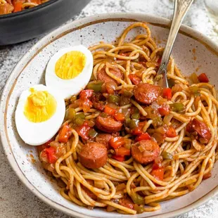 a bowl of spaghetti with a boiled egg