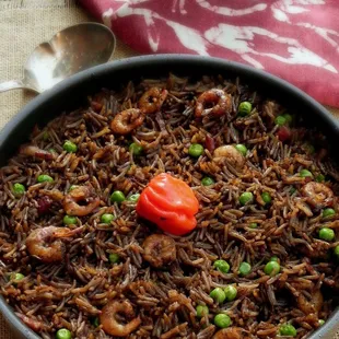 a bowl of rice with peas and shrimp