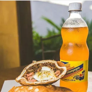 a sandwich and a bottle of soda