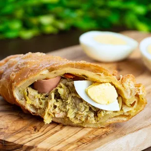 a croissant sandwich on a cutting board