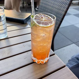 a glass of orange juice on a table