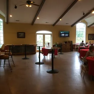 a large dining room with tables and chairs