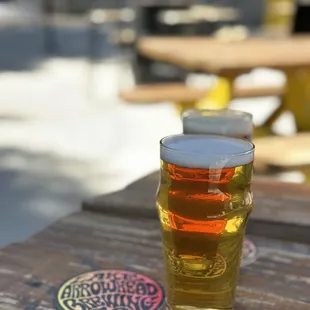 a pint of beer on a picnic table
