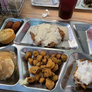 country fried steak with white gravy, sweet potato soufflé, fried okra, mashed potatoes &amp; gravy, cornbread, hushpuppies
