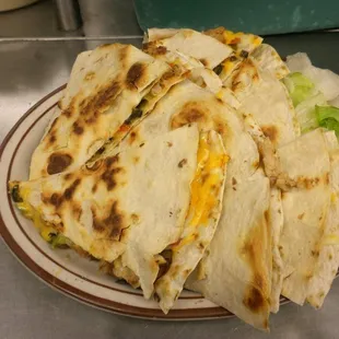 a plate of quesadillas with lettuce