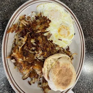 Two eggs with hash browns and an English Muffin