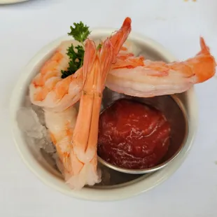 a bowl of shrimp with ketchup