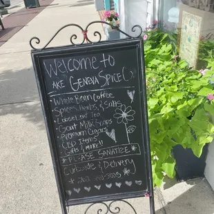 a blackboard sign on a sidewalk