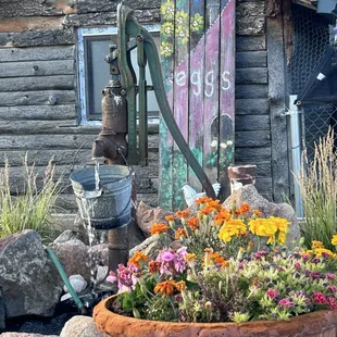 Nice floral display to accent old water pump.