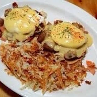 two eggs benedicts on a bed of hash browns